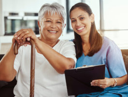 healthcare worker and senior woman sitting