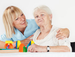 senior woman and carer smiling