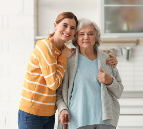 A female and a senior woman smiling together