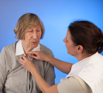 healthcare worker assisting senior woman