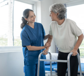 aide and senior woman smiling at each other