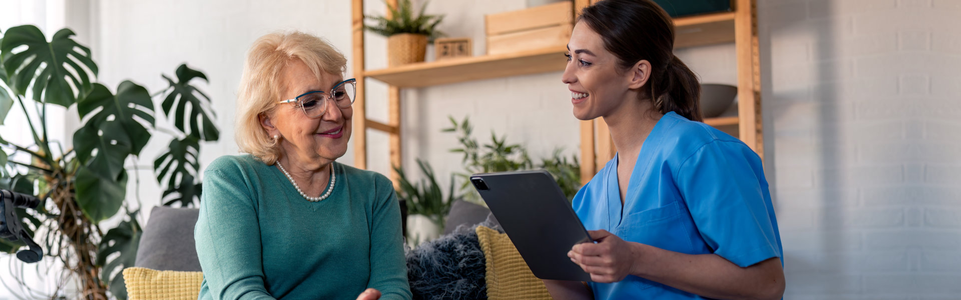 aide and senior woman having a conversation and smiling